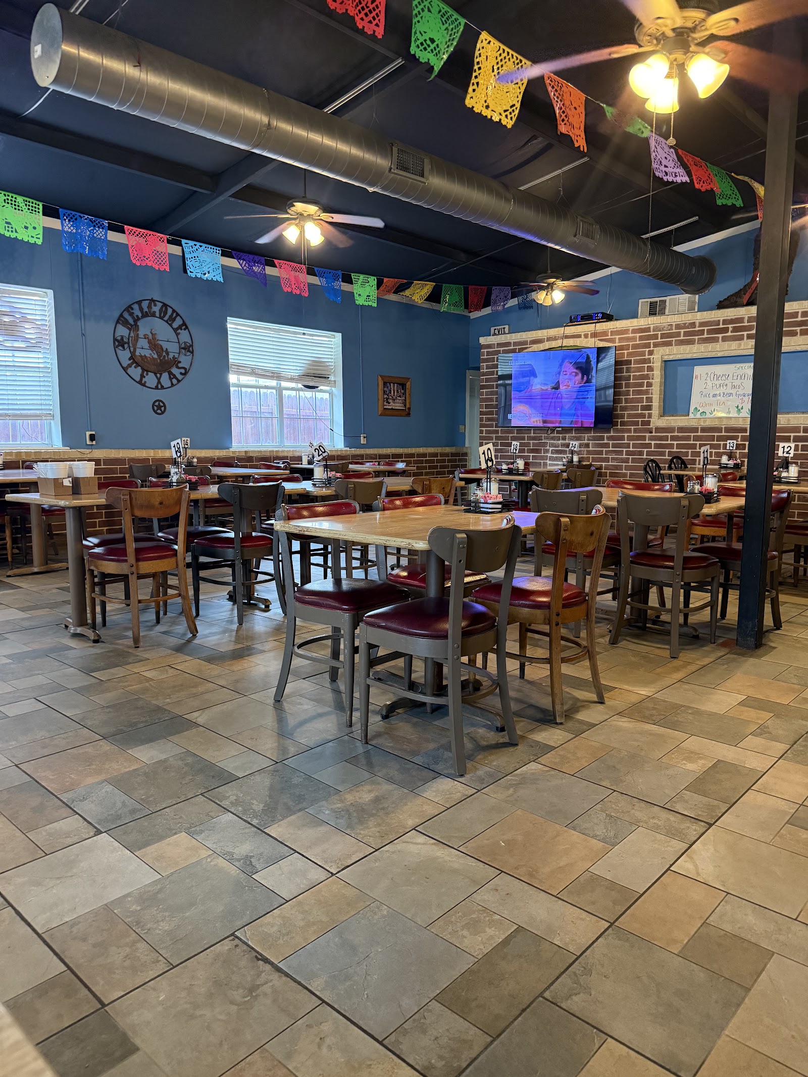 Colorful dining room with papel picado banners at Amaya's Mexican Restaurant