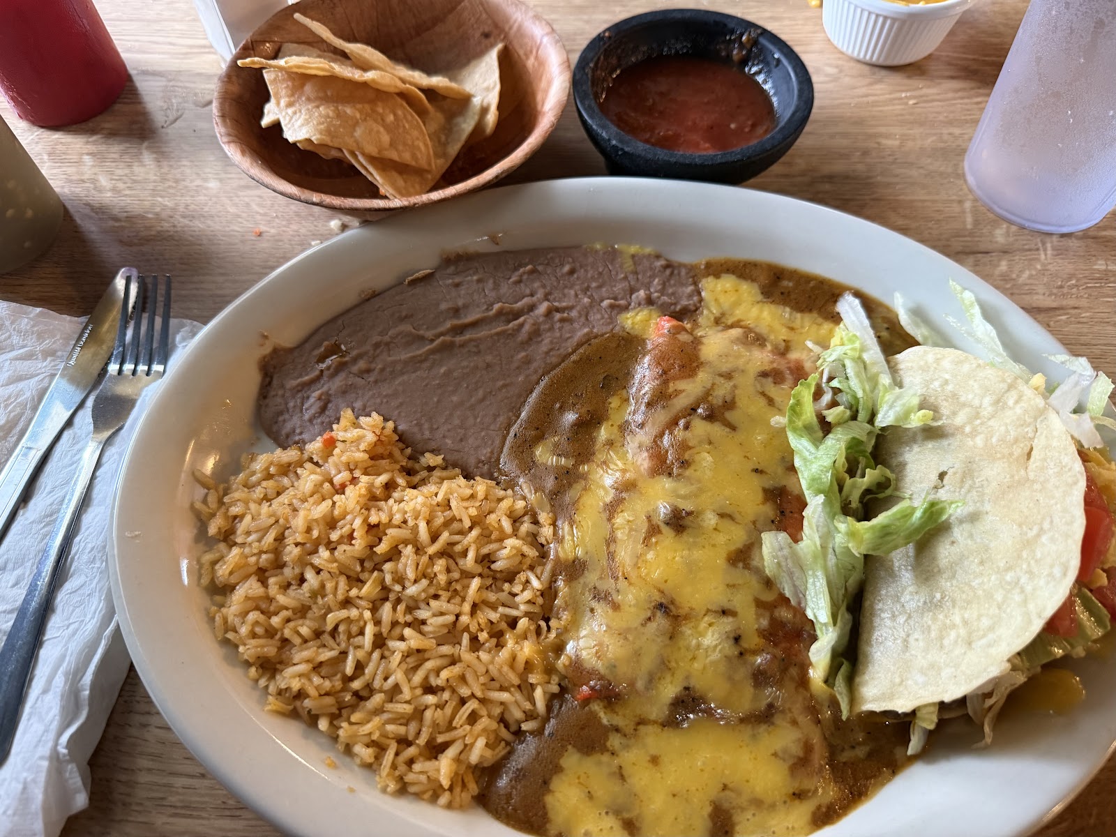 Enchilada plate with rice, beans, and a taco at Amaya's Mexican Restaurant
